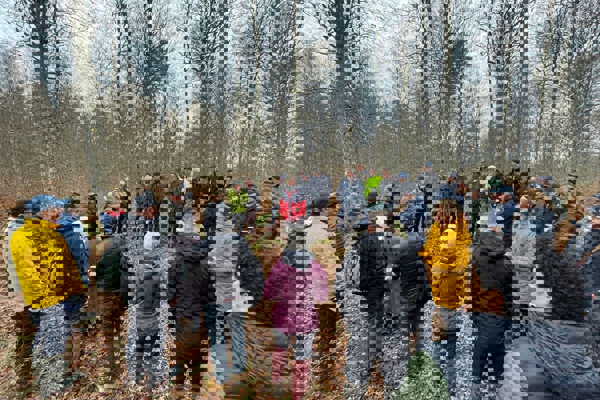 Group of people standing in poplar stand. Photo.